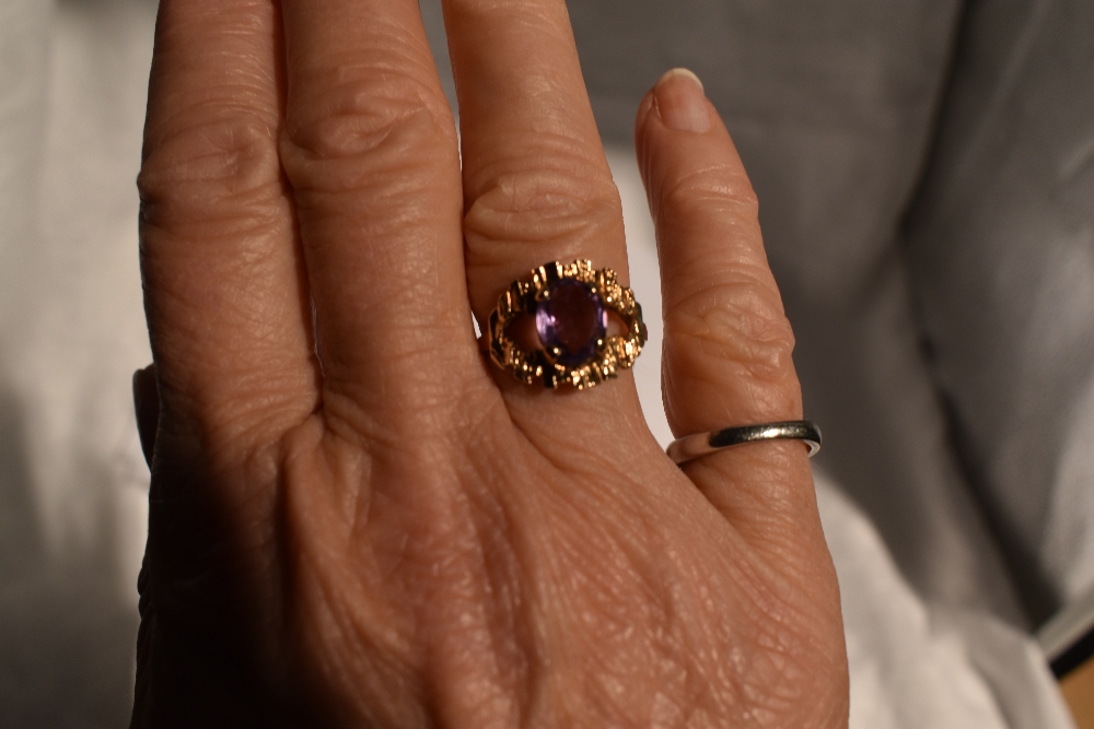 A lady's dress ring having an oval amethyst in a stylised open mount on a 9ct gold loop, size N & - Image 2 of 4