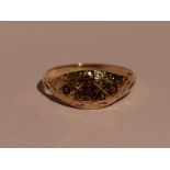 A lady's dress ring of shaped band form having ruby and seed pearl decoration to engraved panel on a