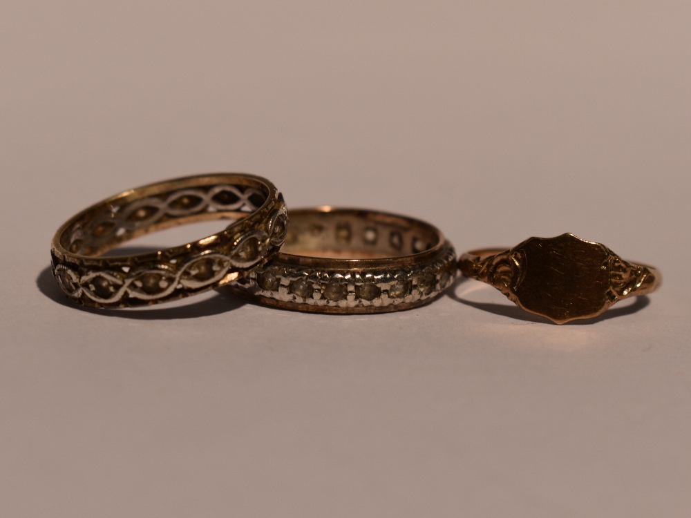 Two lady's eternity rings having white paste stones in white and yellow metal bands stamped 9ct