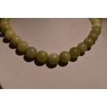 A string of Jadeite style beads of large even form, diameter approx 12mm, approx 16' & 119g