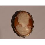 A conch shell cameo brooch depicting a maiden in profile in a decorative 9ct gold mount, approx 7.