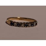 A lady's half eternity ring having five sapphires interspersed by diamond chips in a 9ct gold