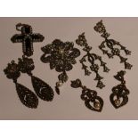 A silver pendant/brooch having marcasite and seed pearl decoration with matched similar earrings,