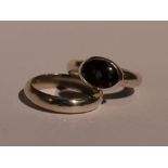 A pair of Artisan made white metal rings including band and obsidian in collared mount, both size J