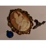 A large conche shell cameo brooch depicting a goddess in the clouds in a pinchbeck deorative