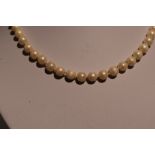 A string of cultured pearls having a 9ct gold decorative box clasp, approx 25' (AF)
