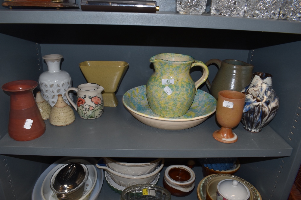 An assortment of studio pottery including jugs, vases and cruet set.