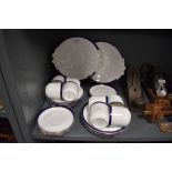 A collection of Tuscan cups and saucers,side plates and cake plates, having white ground with blue