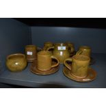 A collection of studio pottery including six cups and saucers,jug and sugar basin.