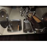 A lot containing a selection of stainless steel trays, toast rack,serving platters and vintage