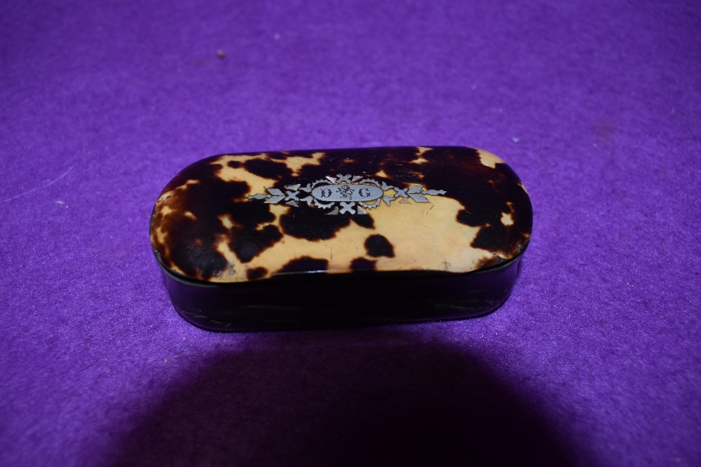 A 19th century Tortoiseshell and horn snuff box with pique inlaid crest.