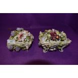 Two basket like trinket dishes or similar, having extensive floral decoration.