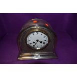 A vintage plated mantle clock of arched form with German movement.
