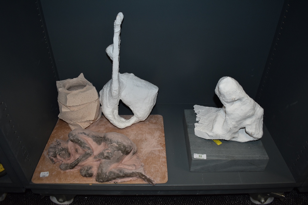 A selection of studio artworks including nude ceramic figure