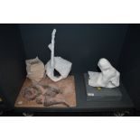 A selection of studio artworks including nude ceramic figure