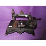 A Victorian crank handled Thomas Mcgrah Triumph sewing machine.