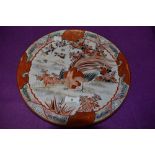 A decorative early 20th century Japanese plate in russet tones depicting cockerel, flowers and
