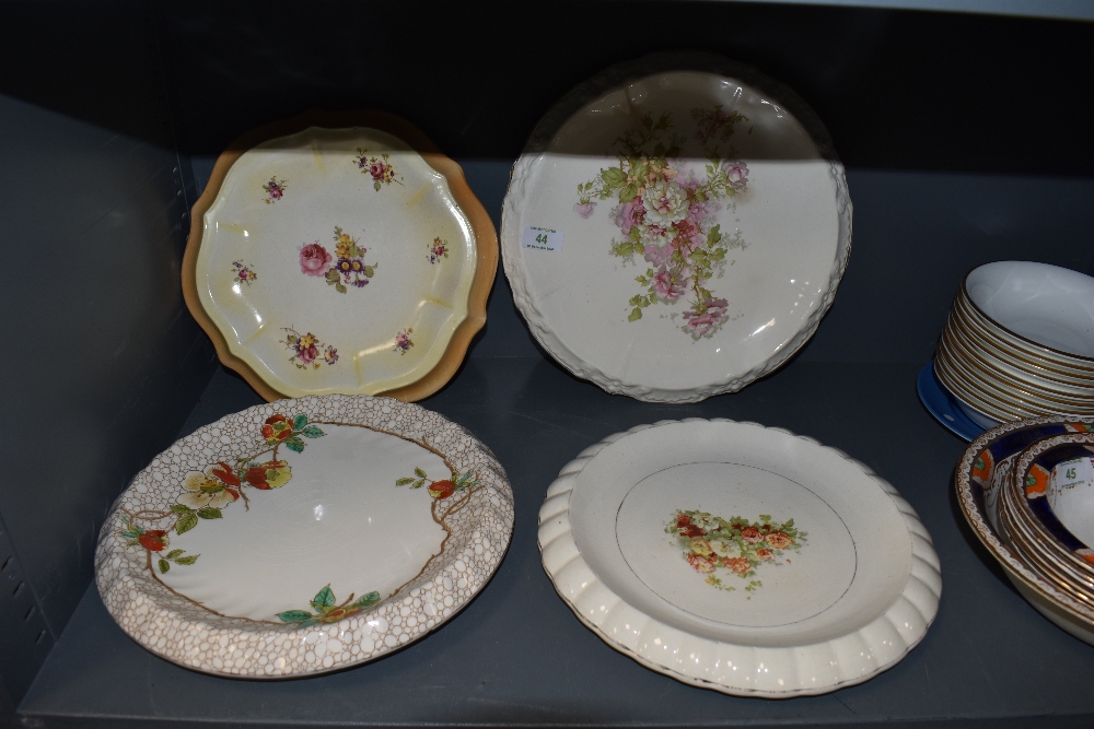 A selection of vintage dessert serving plates having bright floral patterns,five in total.