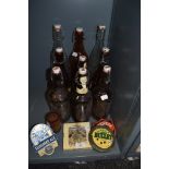 A selection of breweriana interest items including bottles and pump mounted beer advertising