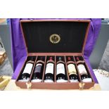 A leather effect Le Grand Amateur Du Vin six bottle case containing six bottles of wine, 2004
