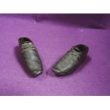 A pair of antique leather and wood childrens clogs/shoes.