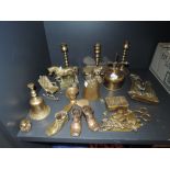 A selection of brass fire side items including candle sticks and terrier dog door knocker