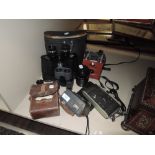 A mixed lot of cameras including instamatic 50 ,binoculars and GPO volt meter or similar.