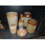 Six items of glazed earthen ware including an advertising bottle of local interest for Alexanders'