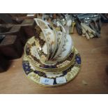 A selection of antique tea cups and saucers with cobolt gold and cream glaze