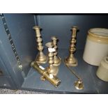 Four brass candle stick holders,a snuffer and a Brass maritime torch possibly a divers torch 'The