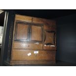 A vintage wooden cabinet with draws of varying sizes and a miniature cupboard housing a selection of