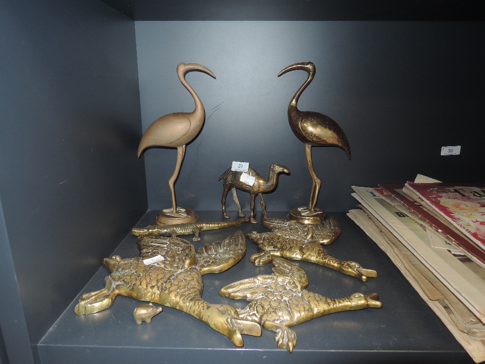 A collection of animal themed brass decorative items including three brass wall mounted flying