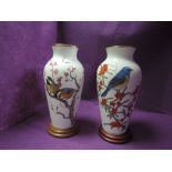 Two large Franklin porcelain vases with stands having birds,flowers and berries to fronts.