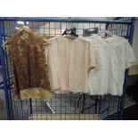 Three vintage 1950s blouses, different styles and sizes.