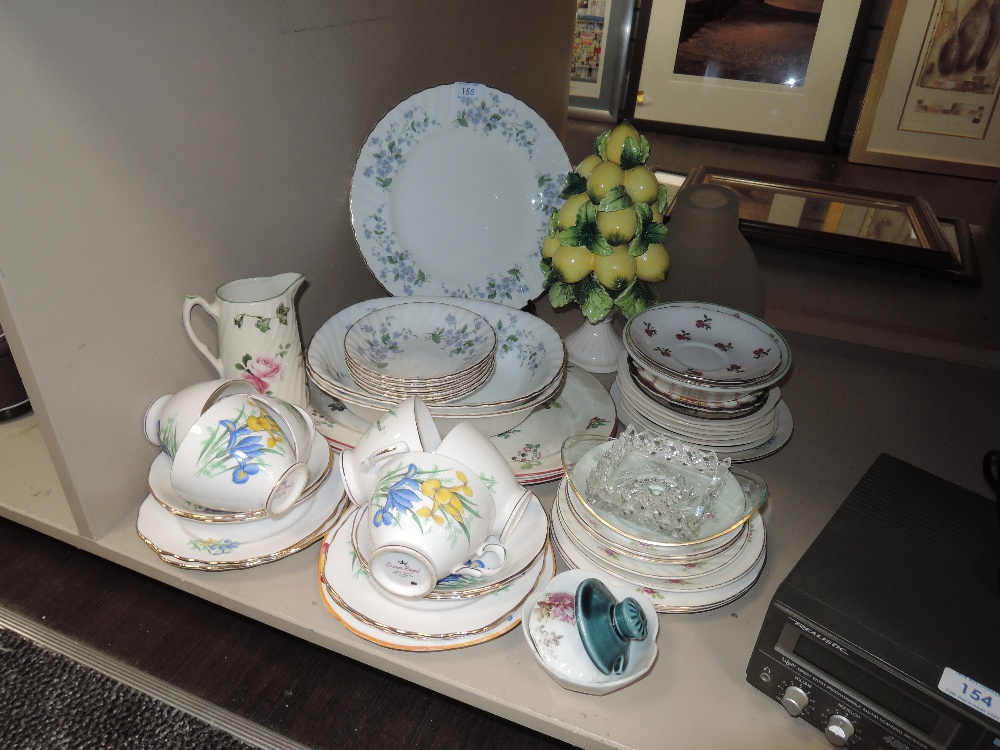 An assortment of ceramics including cups and saucers, platters,serving bowls and more.