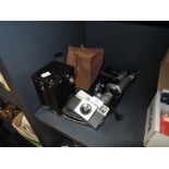 A vintage box camera, a Kodak instamatic 25 and a Velbon tripod.