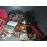 A miscellany of vintage items amongst which are a selection of brushes, trivets, clay pipe,