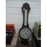 A vintage wooden cased barometer having white glass face dial