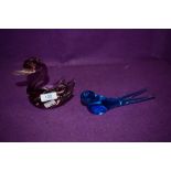 A blue glass swallow and a amethyst tinted swan.