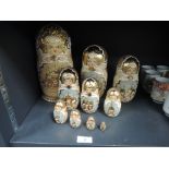 A set of ten Matryoshka dolls having hand painted design with gilt detailing.