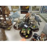 A collection of bird figurines,country artists kestrel,two Peregrine falcons and a thistle green