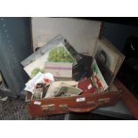 A vintage suitcase containing collection of ephemera,books,postcards(some slightly risqué)and more,
