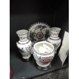 A collection of vases, a planter and charger with stands,having Chinese design with gilt detailing,