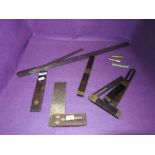 A selection of wood or cabinet makers marking and measuring devices including rulers and bevel