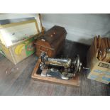 An antique hand cranked sewing machine by Singer 15033657 with case