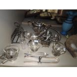 A mixed lot of plated ware and stainless items,including asparagus tongs and toast rack.