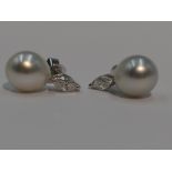 A pair of marquise cut diamond, each approx 0.25ct and South Sea pearl stud earrings in 18ct white