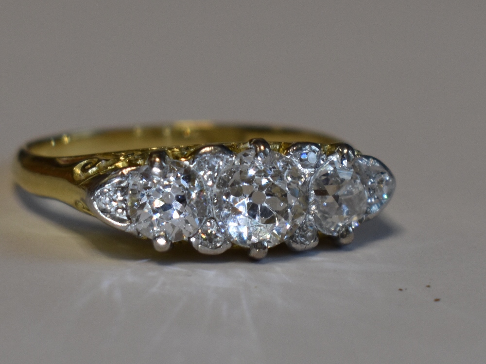 A Victorian lady's dress ring having three graduated diamonds with a border of six diamond chips, - Image 2 of 3