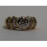 A lady's dress ring having a central diamond, approx 0.5ct to baguette diamond set stepped fanned