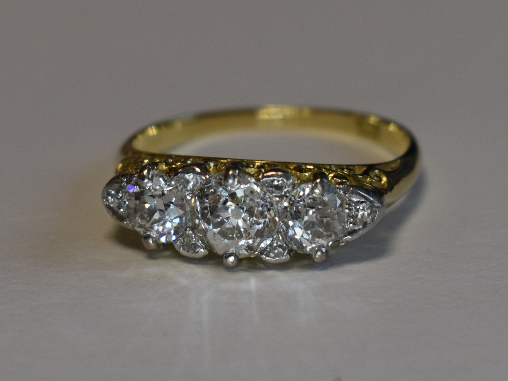 A Victorian lady's dress ring having three graduated diamonds with a border of six diamond chips, - Image 3 of 3